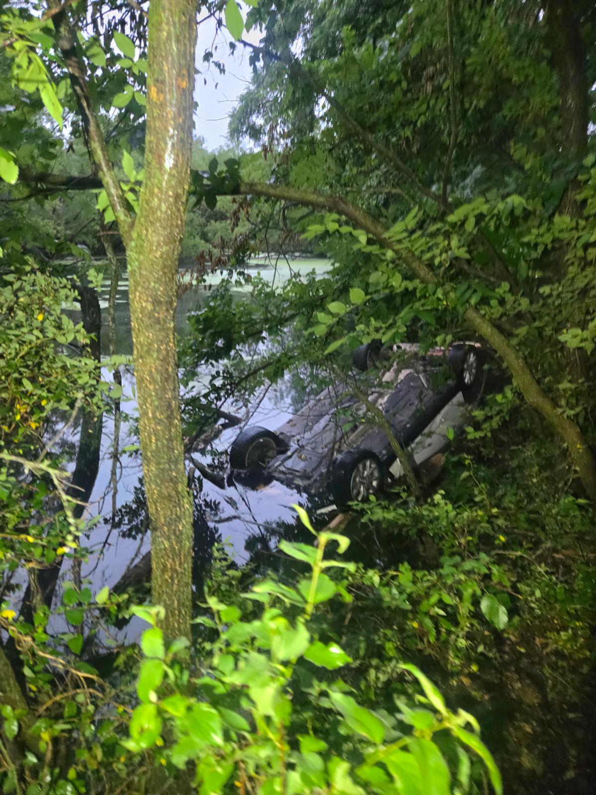 Overturned vehicle submerged in water during an off-road recovery in Shawnee, Oklahoma