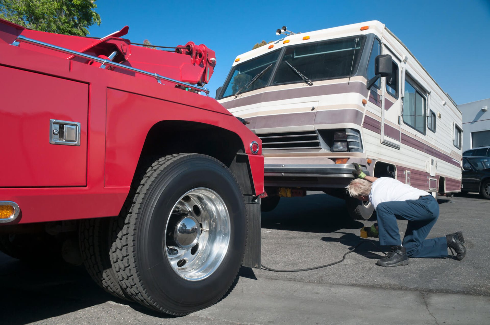 Motor home being towed by a Brown & Sons medium duty tow truck